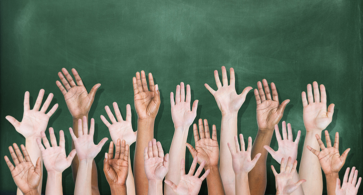 Multiethnic Group of Hands Raised with Blackboard